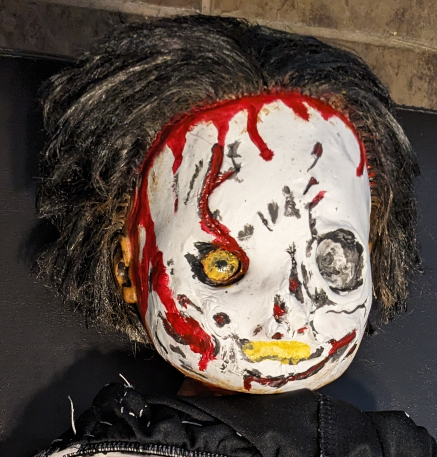 the painted clay face of Vicky Heyes